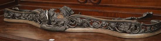 A Louis XV style pierced and cast iron serpentine fender, L.4ft 7in.